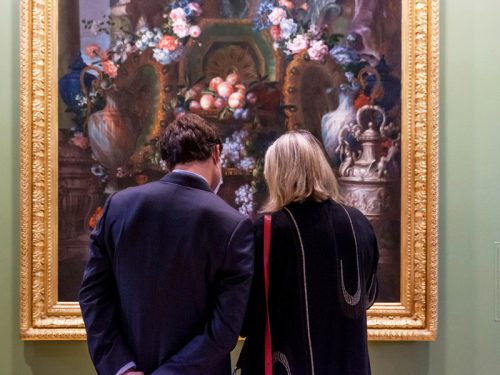 Deux personnes observant un tableau au Petit Château